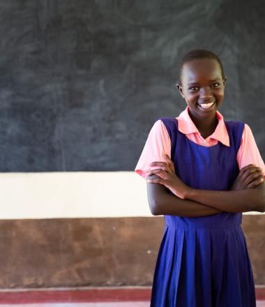 A girl standing proudly at her school