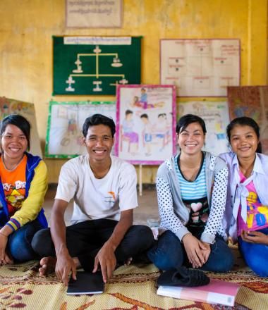 Khmer youth sit on the floor of their community space, Cambodia