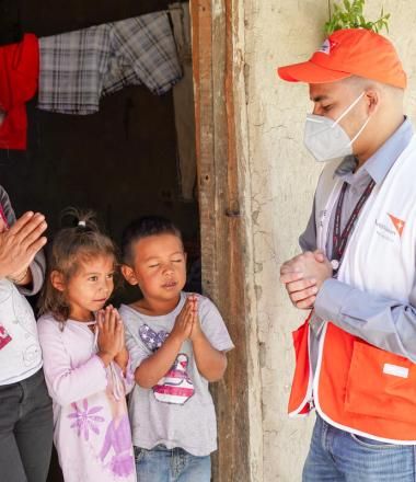 World Vision Staff pray with family in Honduras