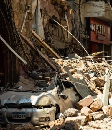 car and building smashed by explosion in Beirut, Lebanon