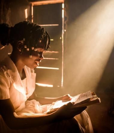 Girl reading in her home with light