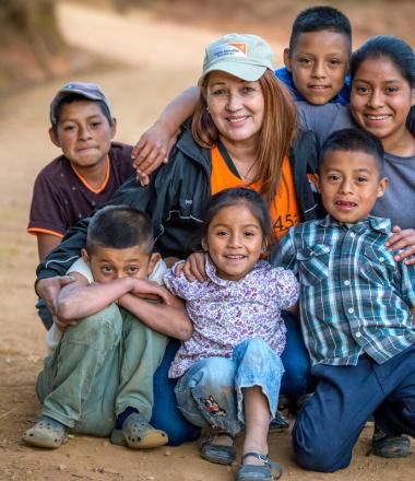 World Vision staff member with children