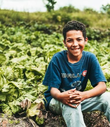 World Food Day Banner_Child sitting in field