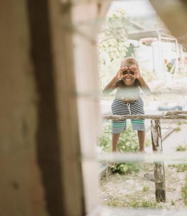 Child looking through window