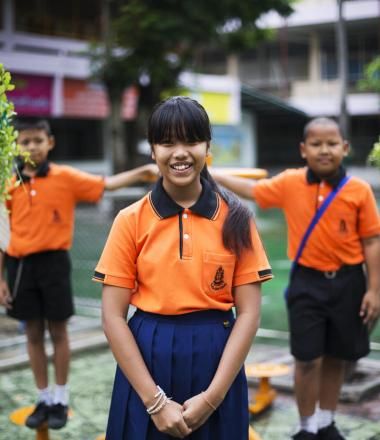 Girl from Thailand in orange shirt