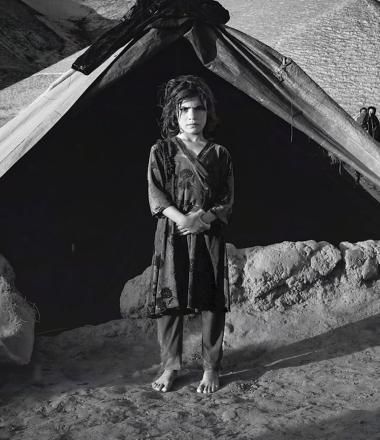 Girl standing in front of tent