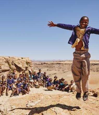 Boy jumping with his arms open