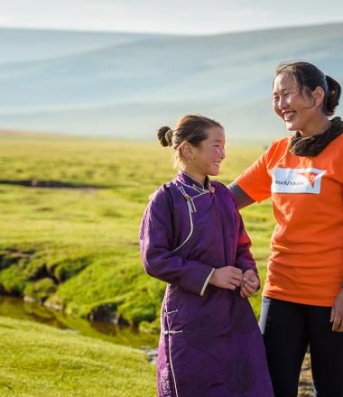 World Vision staff walks with child in Mongolia