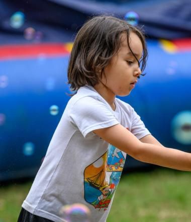 child plays with bubbles