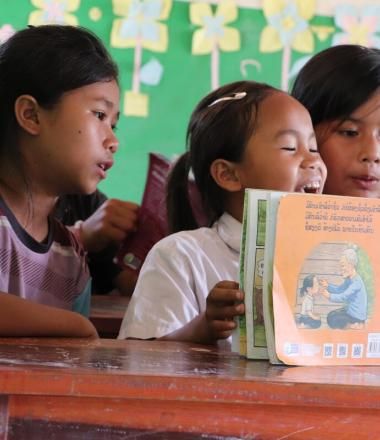 Children read a book together