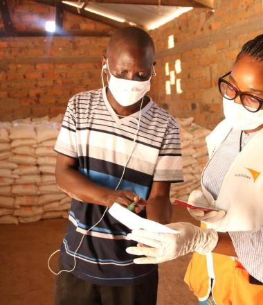 World Vision staff speaks with man 