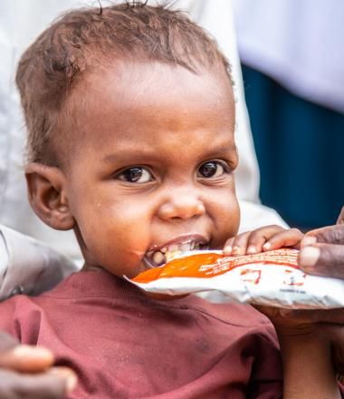small child eats nutritional supplement