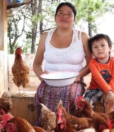 woman and her son with chickens