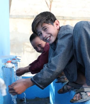 Children use clean water from water storage built by World Vision in their school 