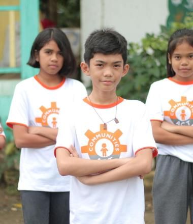 Child leaders from the Philippines stand with arms crossed