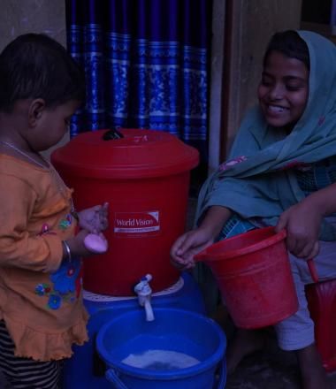 Two children accessing water