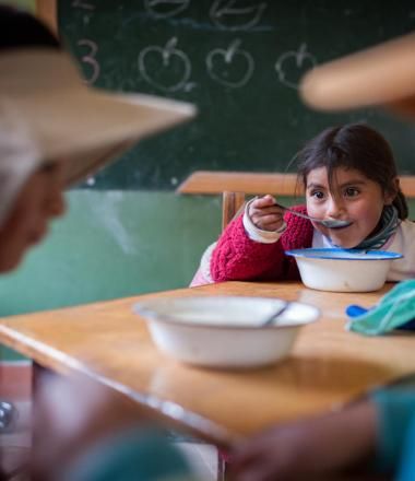 Herlinda, 4, eats lunch at Cotuhuma elementary school in Soracachi, Bolivia.