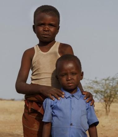 4-year-old Sunday, and his 9-year-old brother Blue, stand in the middle of an almost deserted field.
