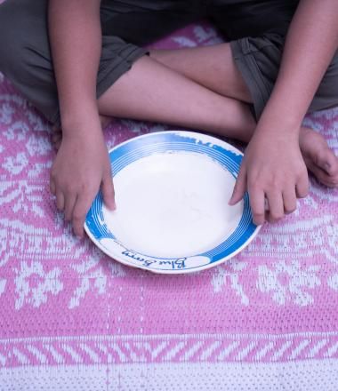 a boy with his empty plate