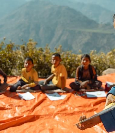 A girl reads book at a Reading Camp