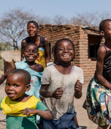Children play happily outside Nored's home