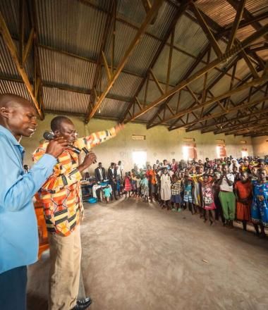 a group of people from Uganda praying