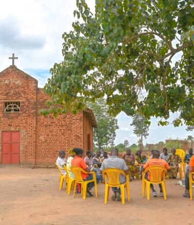 Farmer groups in a meeting with World Vision Staff Infront of the church