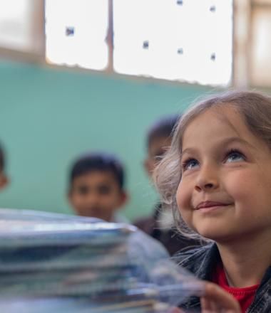 World Refugee Day- Girl learning in one of WVSR's schools