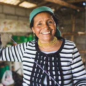 A Peru woman stands in her home