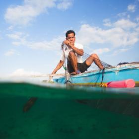 A fisherman in the Philippines uses a microloan to fund his small business