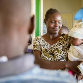 A mother holds her baby at a World Vision facility.