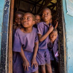 School children waiting and looking out of the doorway