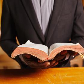 A Pastor in Ghana holds his Bible