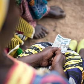 A woman holds cash