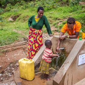 A World Vision employee in Africa showcases a water pump.