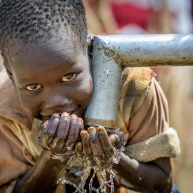 A boy in South Sudan drinks clean water