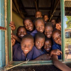 School children looking through window