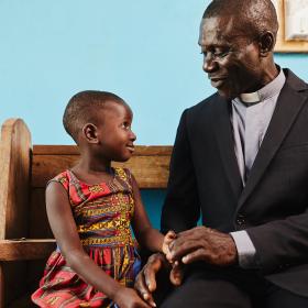 A pastor and child in a church