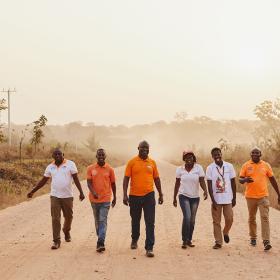 World Vision employees walk down a road in Ghana