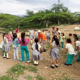 Venezuela Migrant Crisis Response Staff with children playing in a circle