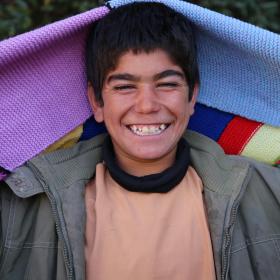 A boy holds a blanket in Eastern Europe