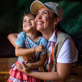 World Vision staff hugging girl