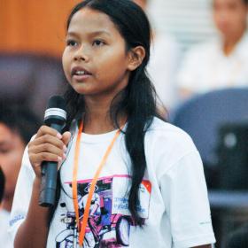 Young Khmer lady speaking on a microphone