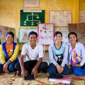 Khmer youth sit on the floor of their community space, Cambodia