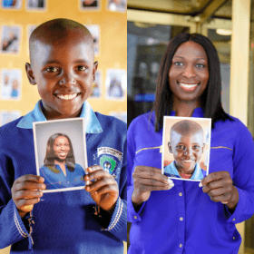 Mary and Yinka holding each other's photos