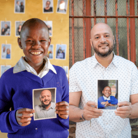 Collins and Joel hold each other's images
