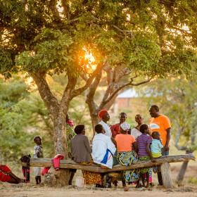 A World Vision staff member meets with the community