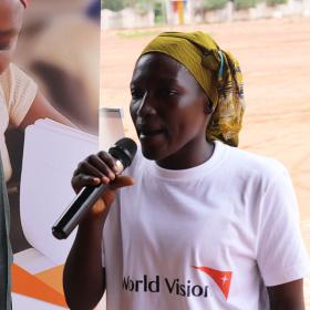 Woman speaking at microphone in Chad