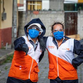 Two World Vision staff members is protective gear against COVID-19