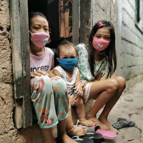 Three children in masks isolated at home